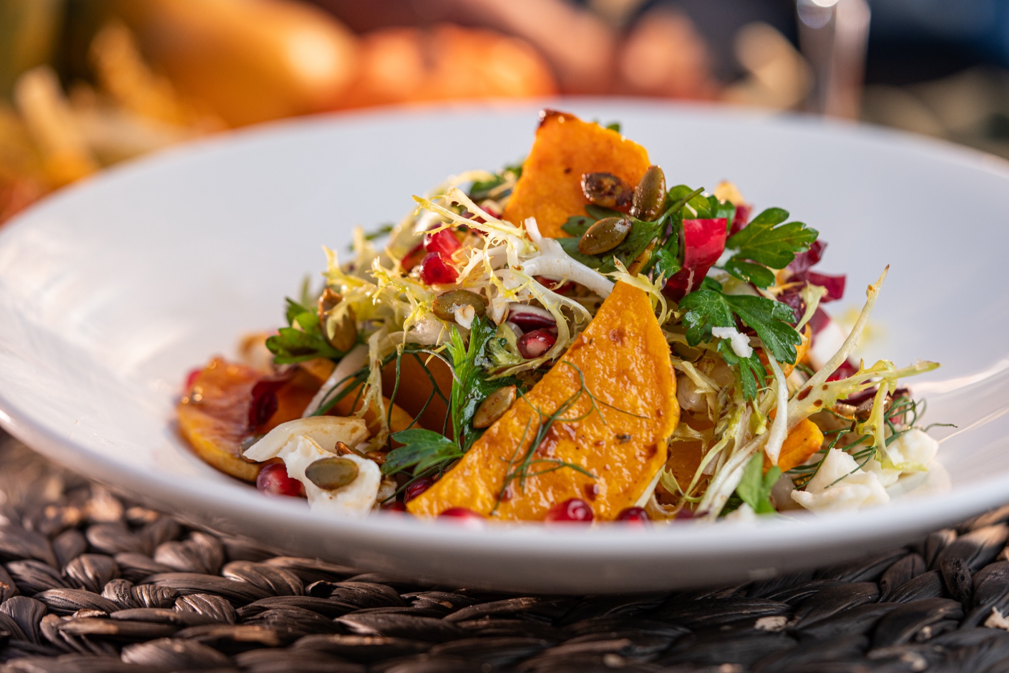 Glazed butternut squash with frisée and pomegranate